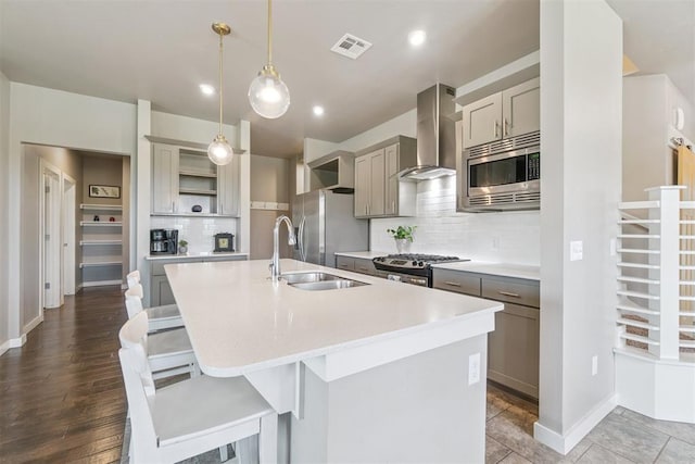 637 NW 179th Cir, Edmond, OK 73012 - kitchen with wall chimney range hood, appliances with stainless steel finishes, open shelves, gray cabinets, and a kitchen island with sink