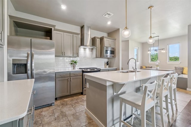 637 NW 179th Cir, Edmond, OK 73012 - kitchen featuring wall chimney exhaust hood, stainless steel appliances, gray cabinetry, and light countertops