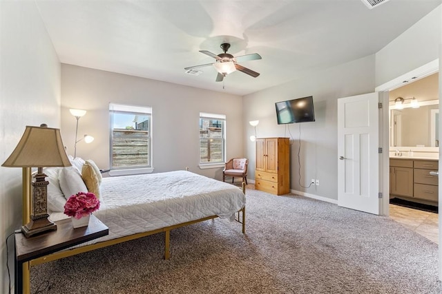 637 NW 179th Cir, Edmond, OK 73012 - bedroom featuring light carpet, connected bathroom, and a ceiling fan