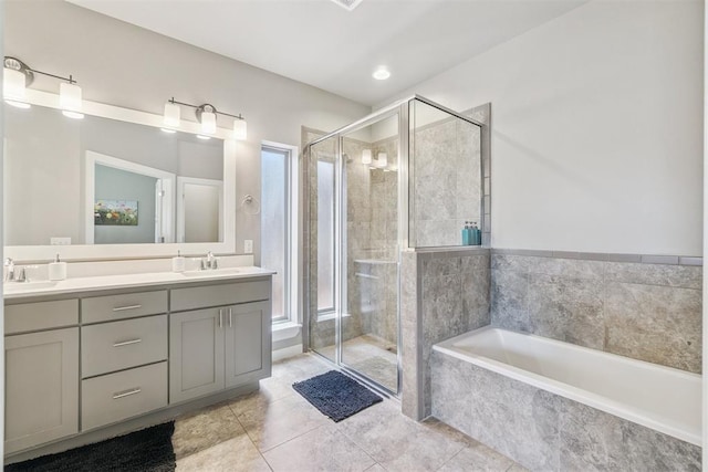 637 NW 179th Cir, Edmond, OK 73012 - full bathroom featuring double vanity, a garden tub, a shower stall, and tile patterned floors