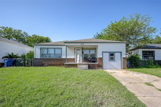 204 E Elder Ave, Duncan, OK 73533 - view of front facade featuring a porch, brick siding, and a front lawn