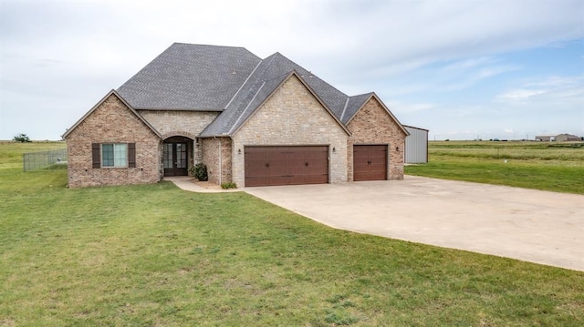 9125 NE Mustang Rd, Piedmont, OK 73078 - french provincial home featuring french doors, an attached garage, a front yard, concrete driveway, and a shingled roof