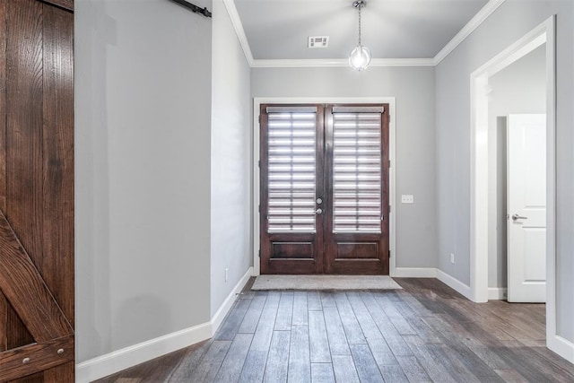 9125 NE Mustang Rd, Piedmont, OK 73078 - foyer entrance with wood finished floors, a barn door, ornamental molding, and french doors