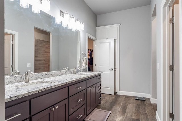 9125 NE Mustang Rd, Piedmont, OK 73078 - full bath featuring wood finished floors, double vanity, and a walk in closet