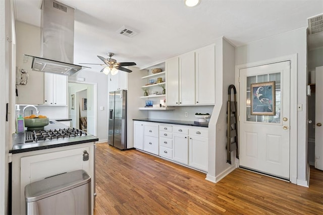 2625 Somerset Pl, Oklahoma City, OK 73116 - kitchen with wall chimney range hood, appliances with stainless steel finishes, dark countertops, and open shelves