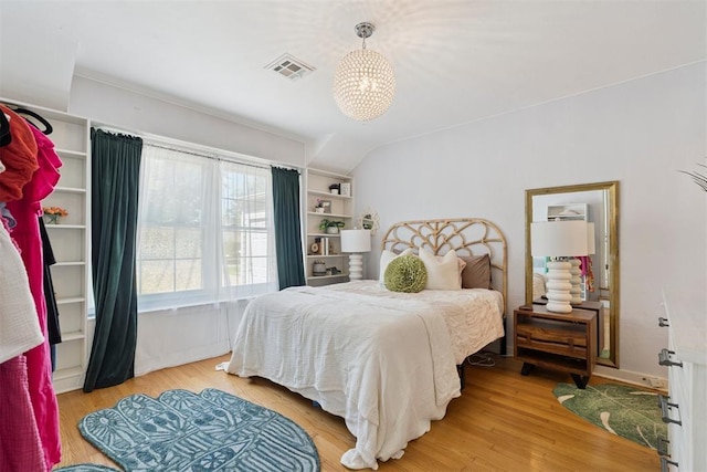 2625 Somerset Pl, Oklahoma City, OK 73116 - bedroom with light wood-type flooring and a chandelier
