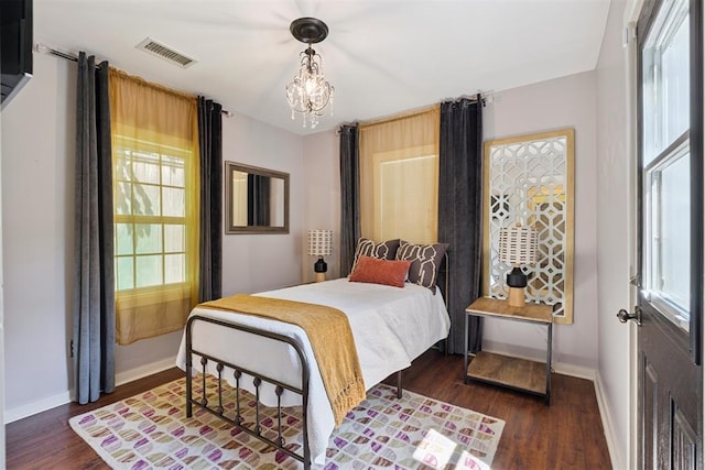 2625 Somerset Pl, Oklahoma City, OK 73116 - bedroom with a chandelier, dark wood-style flooring, and multiple windows