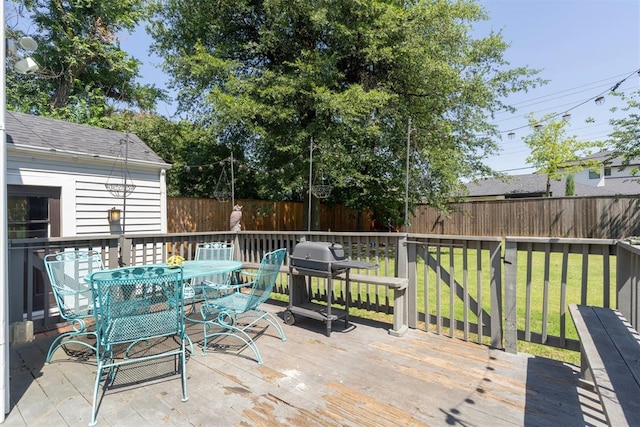 2625 Somerset Pl, Oklahoma City, OK 73116 - deck with outdoor dining area, a fenced backyard, and a grill