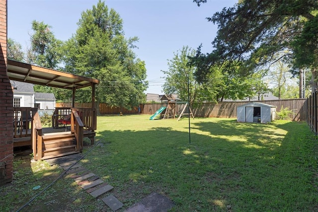 2625 Somerset Pl, Oklahoma City, OK 73116 - fenced backyard featuring a storage shed, a playground, and a wooden deck