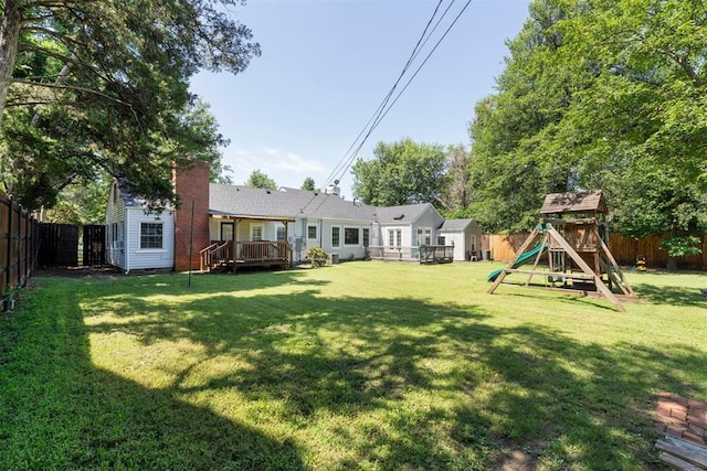 2625 Somerset Pl, Oklahoma City, OK 73116 - fenced backyard featuring a playground and a wooden deck