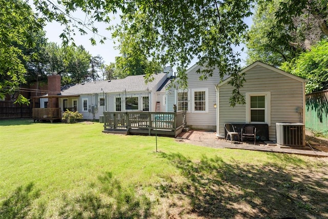 2625 Somerset Pl, Oklahoma City, OK 73116 - back of property with a deck, a yard, and a chimney