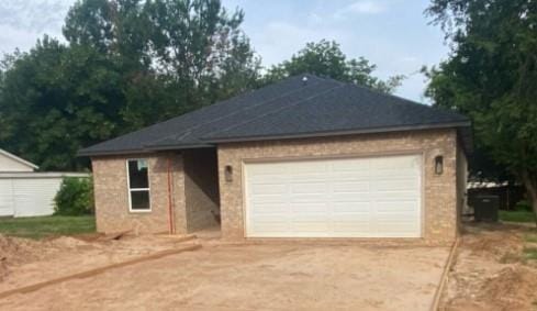 2121 Stevens Dr, Midwest City, OK 73110 - view of front of home with concrete driveway, an attached garage, and brick siding