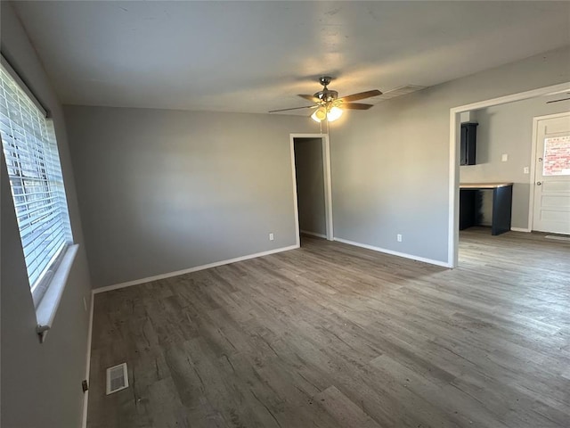 1501 W Watts St, El Reno, OK 73036 - empty room with a ceiling fan and wood finished floors