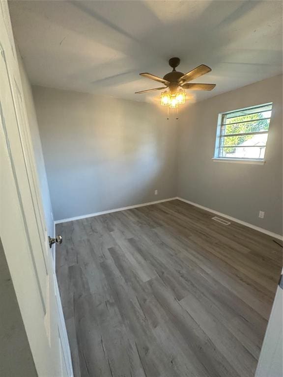 1501 W Watts St, El Reno, OK 73036 - empty room with wood finished floors and ceiling fan