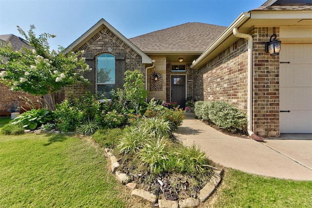 9920 NW 142nd St, Yukon, OK 73099 - entrance to property with brick siding, an attached garage, a lawn, and a shingled roof