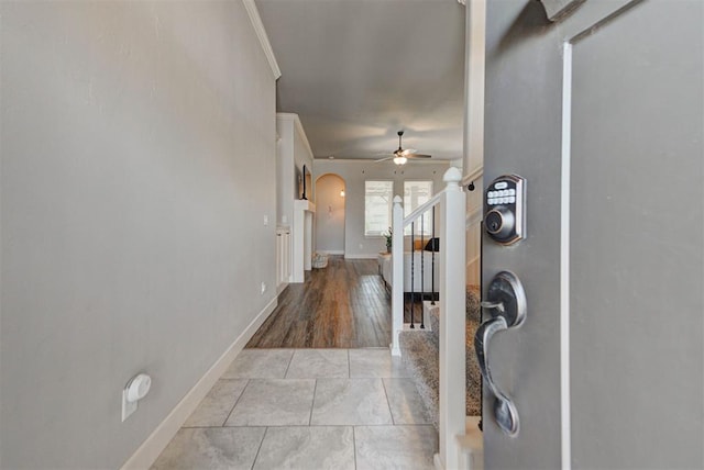 9920 NW 142nd St, Yukon, OK 73099 - foyer featuring arched walkways, ceiling fan, crown molding, and stairway