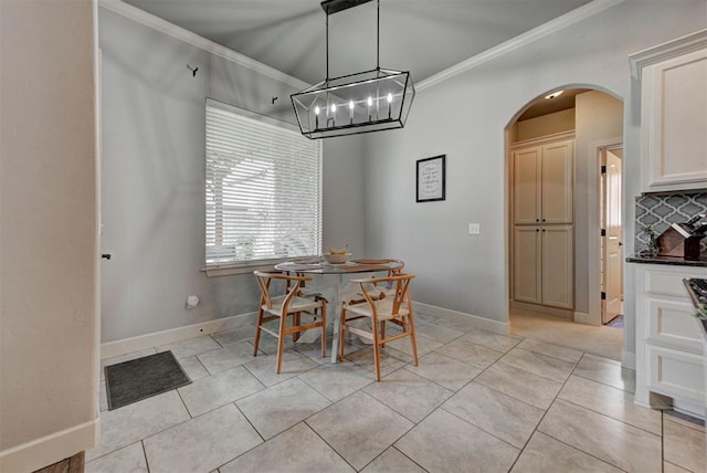 9920 NW 142nd St, Yukon, OK 73099 - dining room featuring arched walkways, ornamental molding, a chandelier, and light tile patterned flooring