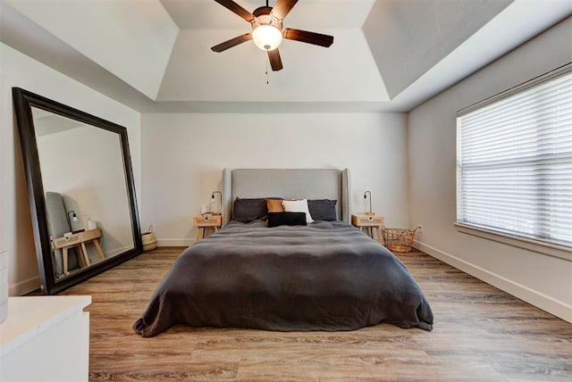 9920 NW 142nd St, Yukon, OK 73099 - bedroom featuring a raised ceiling, wood finished floors, lofted ceiling, and a ceiling fan