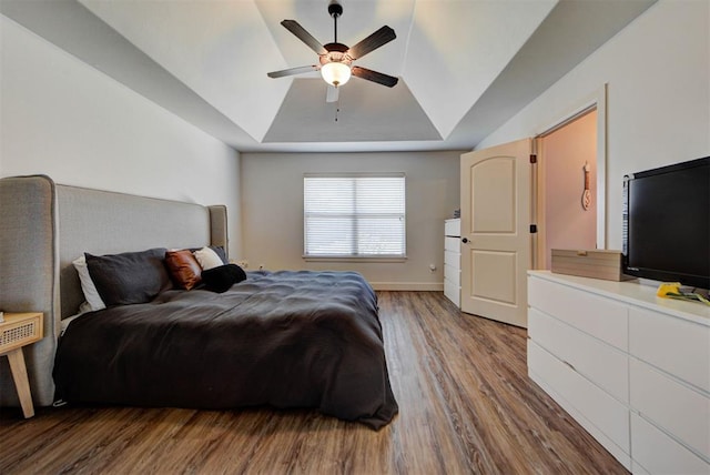 9920 NW 142nd St, Yukon, OK 73099 - bedroom featuring a raised ceiling, wood finished floors, and a ceiling fan