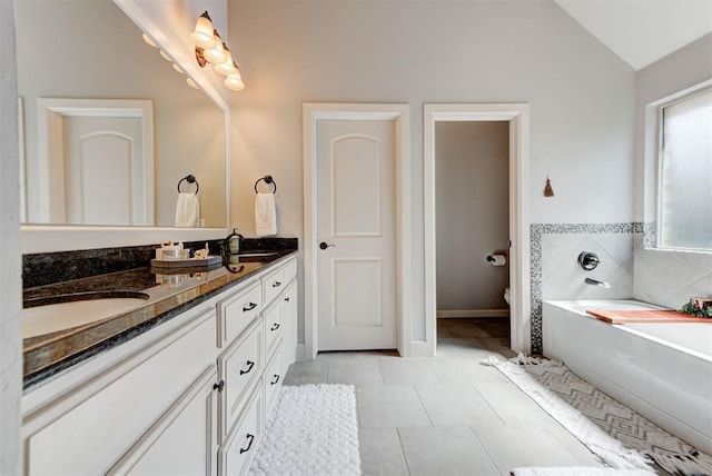 9920 NW 142nd St, Yukon, OK 73099 - full bathroom featuring double vanity, a bath, tile patterned flooring, and lofted ceiling