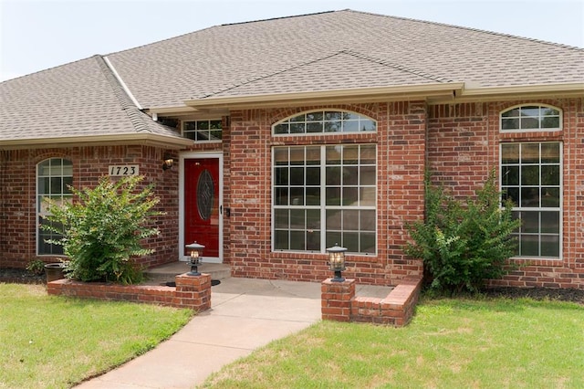 1723 Grey Hawk Rd, Edmond, OK 73003 - single story home with a shingled roof, a front lawn, and brick siding