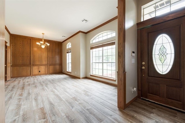 1723 Grey Hawk Rd, Edmond, OK 73003 - entrance foyer with a chandelier, ornamental molding, and light wood-style flooring