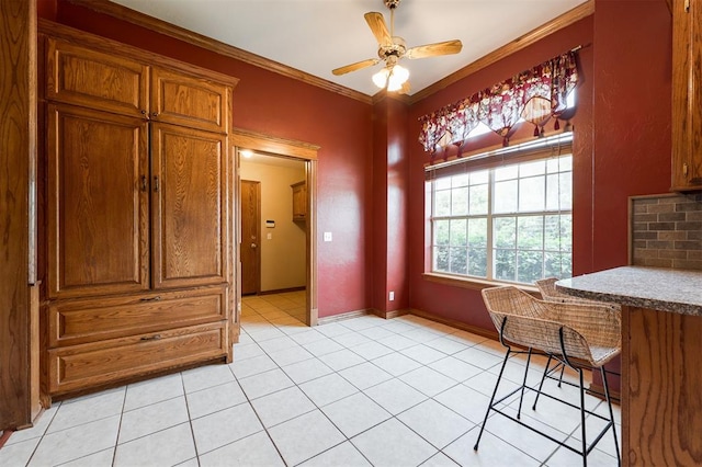 1723 Grey Hawk Rd, Edmond, OK 73003 - unfurnished dining area featuring a ceiling fan, light tile patterned floors, and crown molding