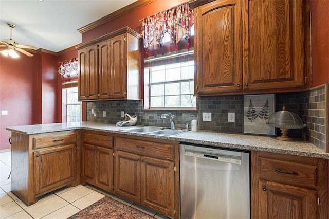 1723 Grey Hawk Rd, Edmond, OK 73003 - kitchen with dishwasher, light tile patterned floors, a peninsula, decorative backsplash, and crown molding
