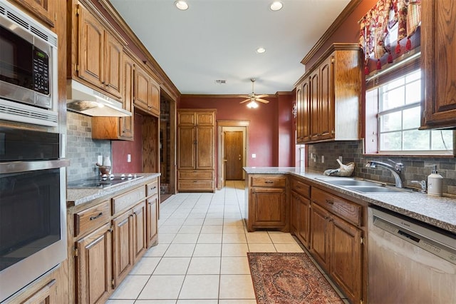 1723 Grey Hawk Rd, Edmond, OK 73003 - kitchen with stainless steel appliances, under cabinet range hood, light tile patterned floors, tasteful backsplash, and a ceiling fan
