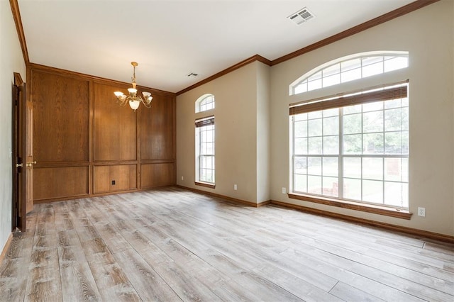 1723 Grey Hawk Rd, Edmond, OK 73003 - empty room featuring a chandelier, ornamental molding, and light wood finished floors