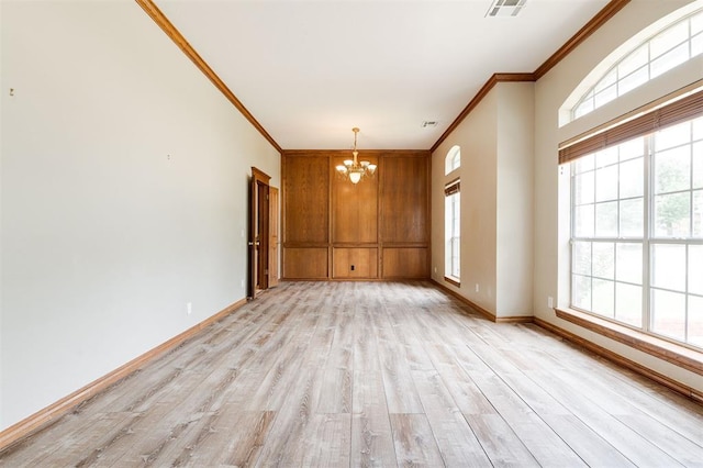 1723 Grey Hawk Rd, Edmond, OK 73003 - unfurnished room featuring crown molding, a chandelier, healthy amount of natural light, and light wood finished floors