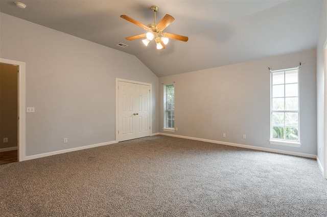 1723 Grey Hawk Rd, Edmond, OK 73003 - empty room with plenty of natural light, ceiling fan, carpet, vaulted ceiling, and a smoke detector