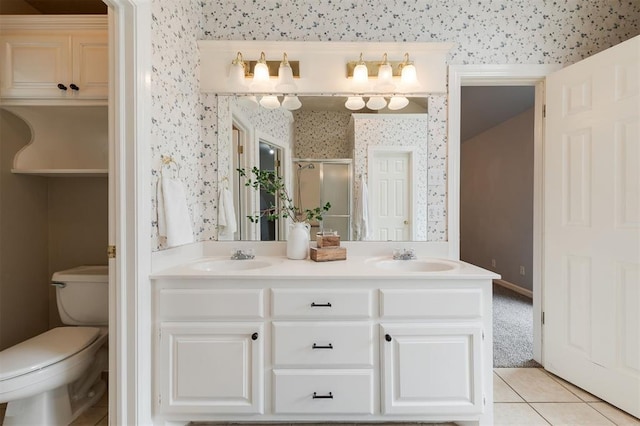 1723 Grey Hawk Rd, Edmond, OK 73003 - full bathroom with a shower stall, wallpapered walls, double vanity, and tile patterned floors