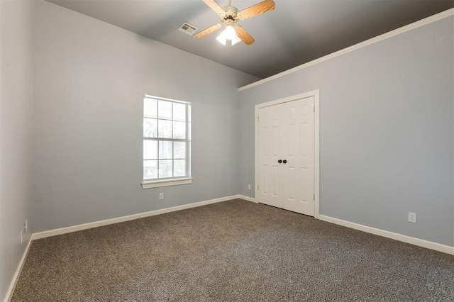 1723 Grey Hawk Rd, Edmond, OK 73003 - empty room featuring ceiling fan and dark carpet