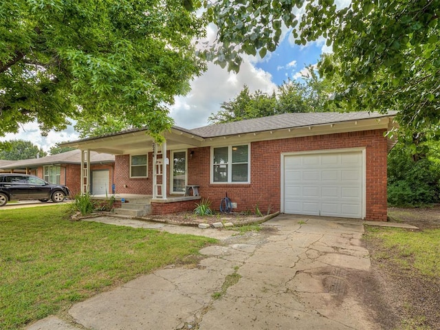 2244 Downing St, Oklahoma City, OK 73120 - ranch-style house featuring a garage, brick siding, a front lawn, and concrete driveway
