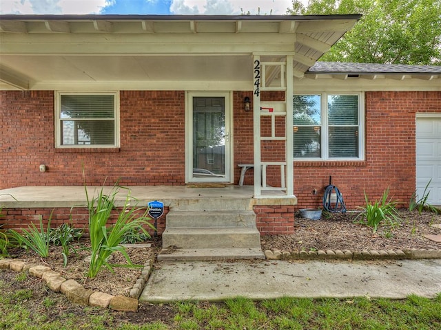 2244 Downing St, Oklahoma City, OK 73120 - property entrance with brick siding and an attached garage