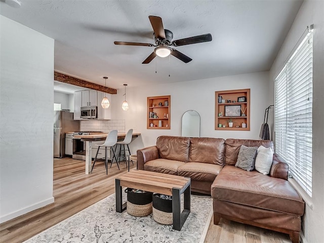 2244 Downing St, Oklahoma City, OK 73120 - living room featuring a ceiling fan and light wood-style floors