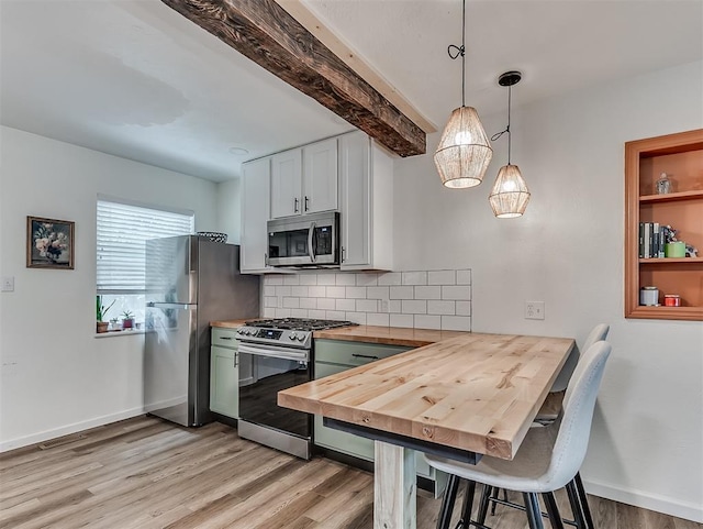 2244 Downing St, Oklahoma City, OK 73120 - kitchen with stainless steel appliances, wood counters, light wood-style flooring, tasteful backsplash, and a kitchen breakfast bar