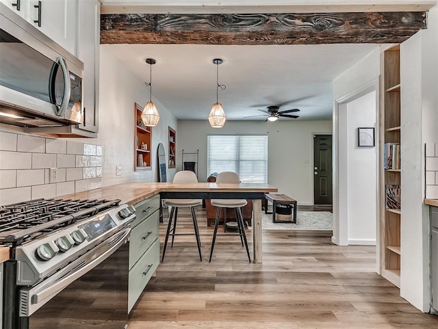2244 Downing St, Oklahoma City, OK 73120 - kitchen with stainless steel appliances, tasteful backsplash, a desk, a ceiling fan, and a peninsula