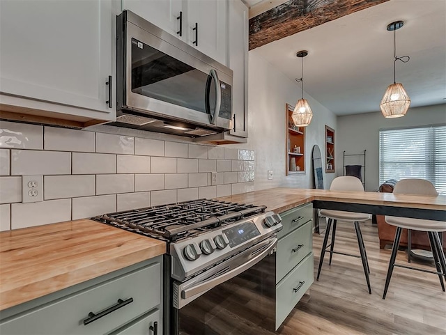 2244 Downing St, Oklahoma City, OK 73120 - kitchen with appliances with stainless steel finishes, butcher block counters, light wood-style flooring, tasteful backsplash, and beam ceiling