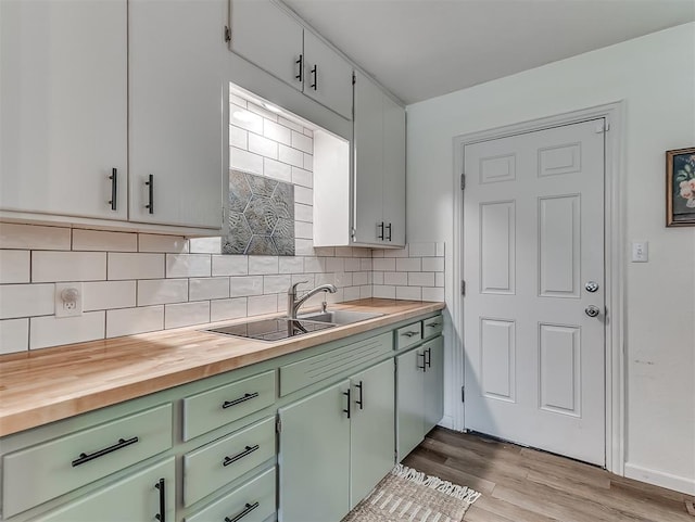 2244 Downing St, Oklahoma City, OK 73120 - kitchen with green cabinets, backsplash, wood finished floors, and butcher block countertops