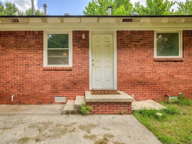 2244 Downing St, Oklahoma City, OK 73120 - property entrance featuring brick siding and crawl space
