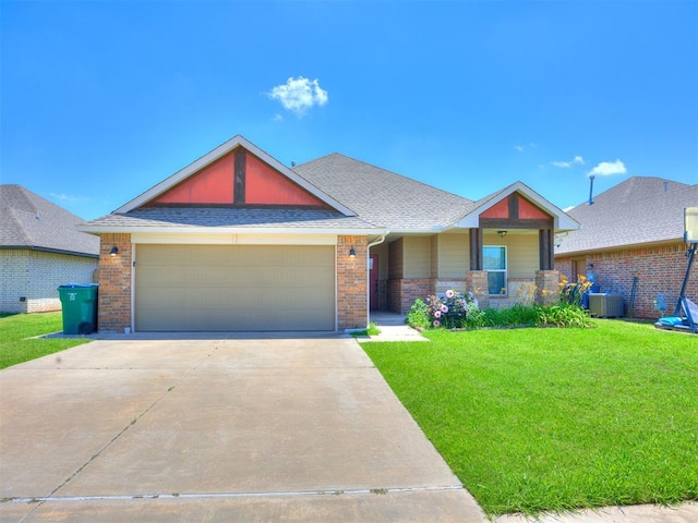 2208 Rivera Rd, Yukon, OK 73099 - craftsman house with concrete driveway, brick siding, a front yard, a garage, and a shingled roof