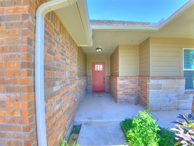 2208 Rivera Rd, Yukon, OK 73099 - view of exterior entry featuring brick siding and a shingled roof