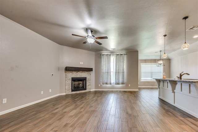 2208 Rivera Rd, Yukon, OK 73099 - unfurnished living room featuring ceiling fan, dark wood-style floors, and a fireplace