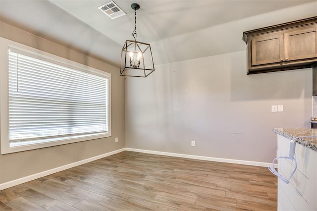 2208 Rivera Rd, Yukon, OK 73099 - unfurnished dining area featuring a chandelier, light wood finished floors, and healthy amount of natural light
