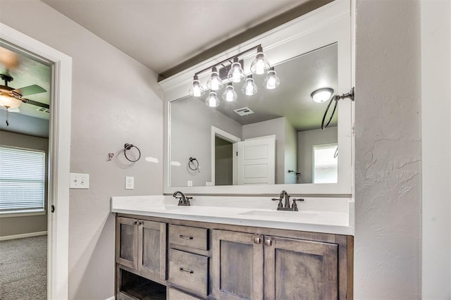 2208 Rivera Rd, Yukon, OK 73099 - full bath featuring double vanity, healthy amount of natural light, and a ceiling fan