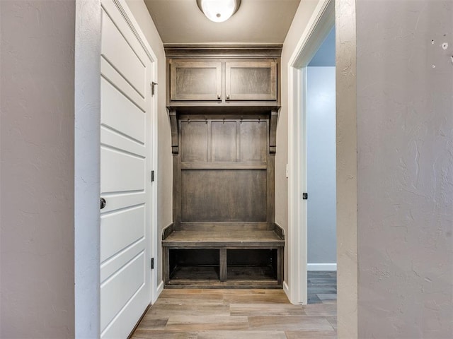 2208 Rivera Rd, Yukon, OK 73099 - mudroom featuring light wood-style floors and a textured wall