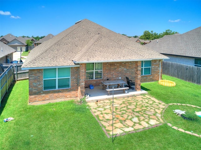 2208 Rivera Rd, Yukon, OK 73099 - back of property featuring a shingled roof, brick siding, a fenced backyard, and a patio area