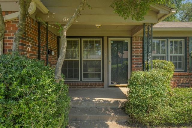 1627 Sheffield Rd, Oklahoma City, OK 73120 - doorway to property featuring brick siding and a porch